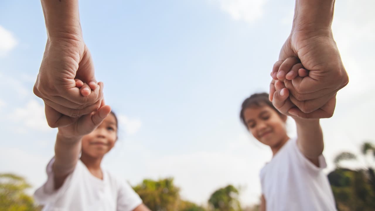 Parents holding children's hands