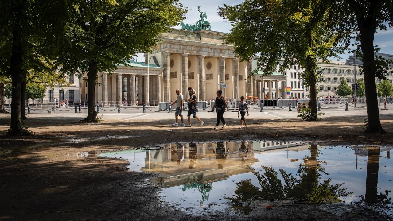 Tourists walking by Brandenbuger Tor in Berlin 