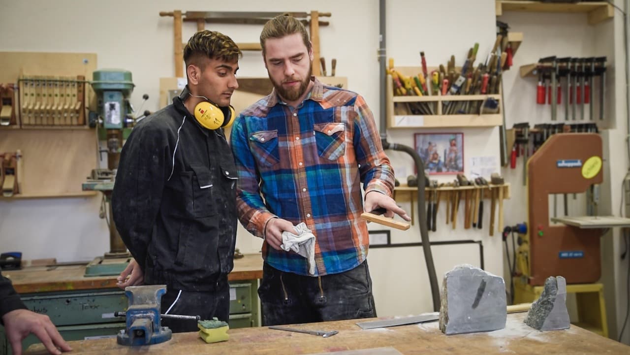 Two man speaking in a workshop