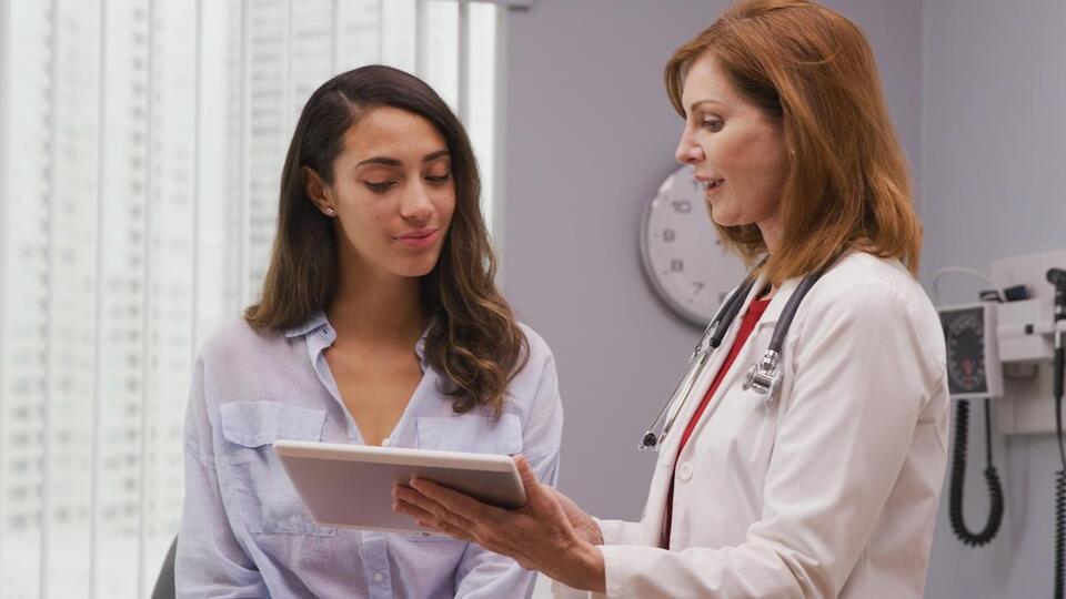 Female doctor talking to a female patient