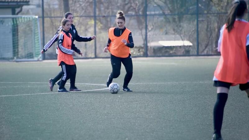 women playing football in a sports club